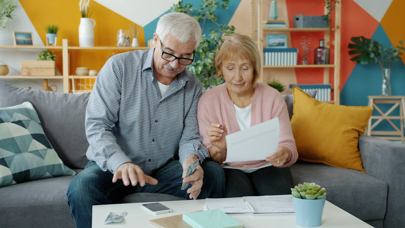 Senior couple reviewing Medicare paperwork together at home